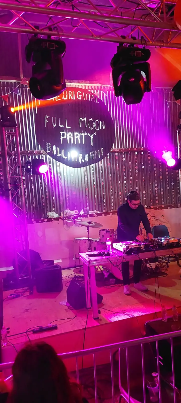 Behind the decks in purple light